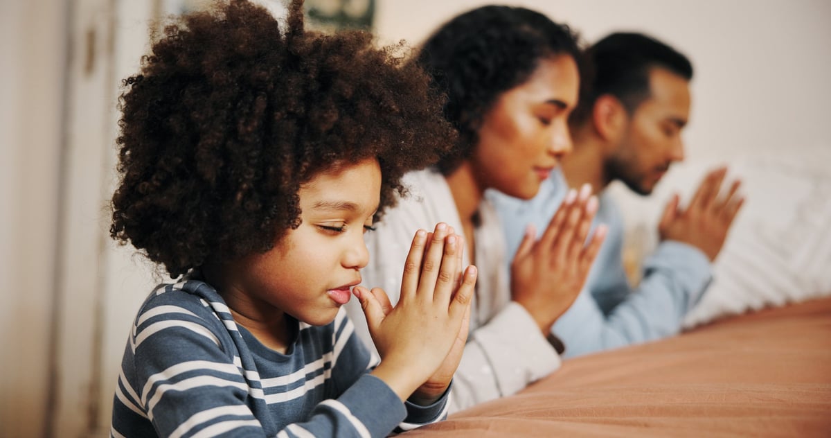 Family praying together at home, Christian faith prayer