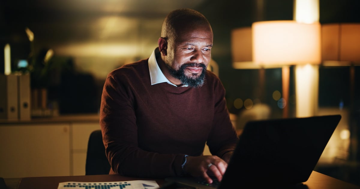 Christian entrepreneur businessman working on laptop at desk